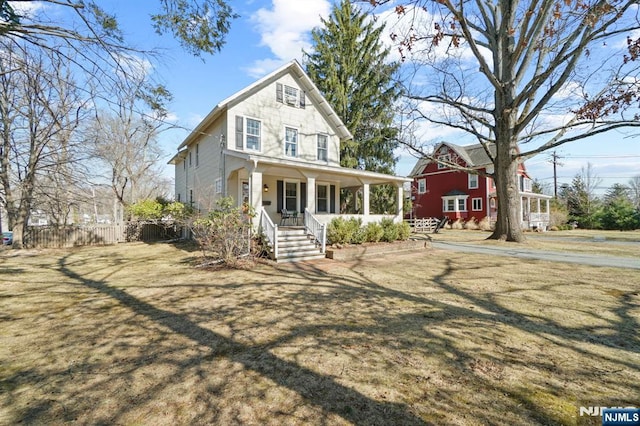 view of front of house featuring a porch and fence