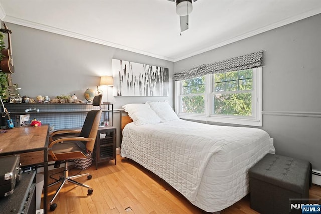 bedroom with ornamental molding, a ceiling fan, and wood-type flooring