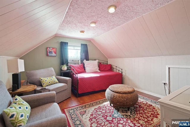 bedroom featuring wood finished floors and vaulted ceiling