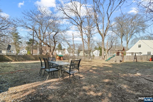 view of yard featuring a playground and a fenced backyard