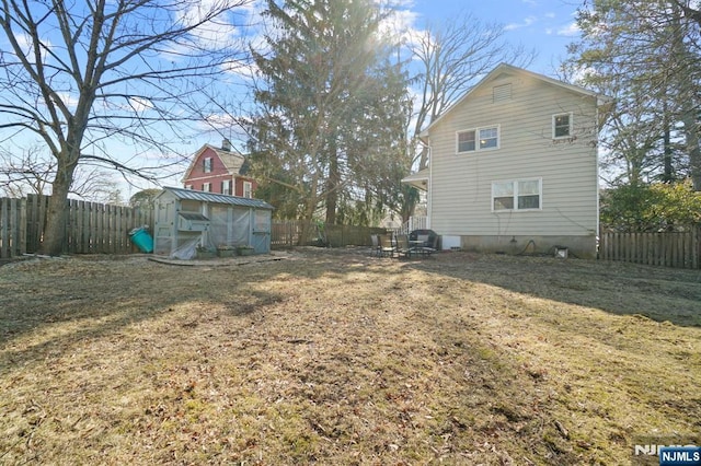 exterior space with an outbuilding and a fenced backyard