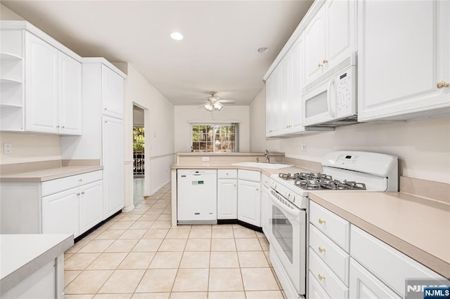 kitchen with white appliances, light countertops, and open shelves