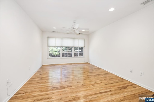 empty room featuring visible vents, recessed lighting, a ceiling fan, and wood finished floors