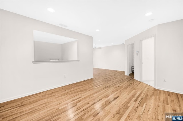 spare room with visible vents, recessed lighting, wood finished floors, and baseboards