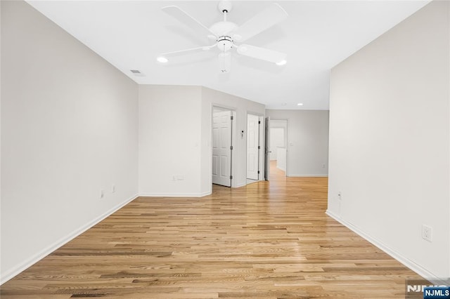 unfurnished room featuring visible vents, baseboards, light wood-type flooring, and a ceiling fan