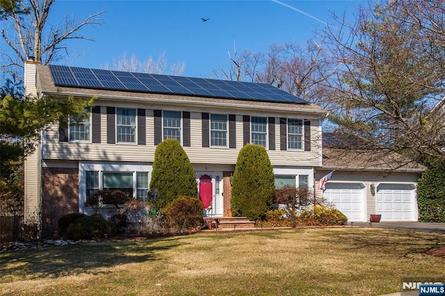 colonial house with brick siding, solar panels, and a front yard