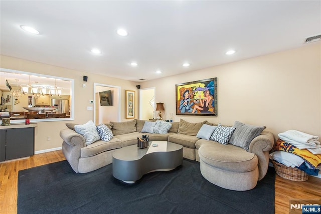 living room with recessed lighting, light wood-style floors, and visible vents