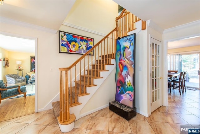 stairway featuring tile patterned floors, baseboards, and ornamental molding