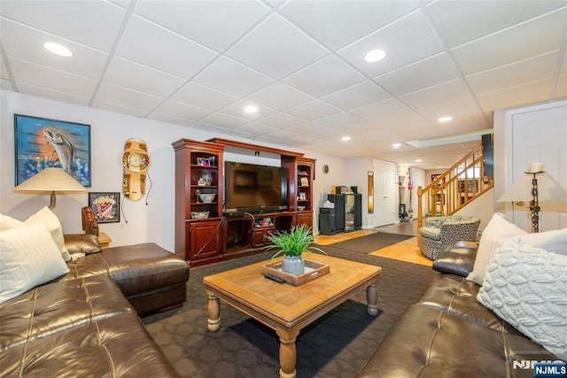 living area featuring stairway, recessed lighting, and a drop ceiling