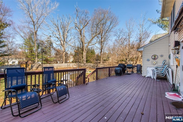 wooden terrace featuring a fenced backyard