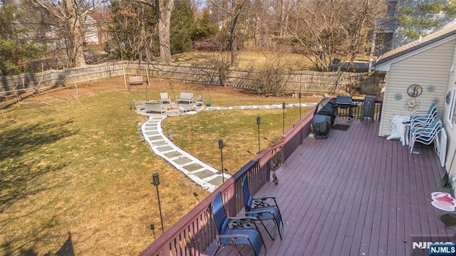 wooden deck with a yard and a fenced backyard