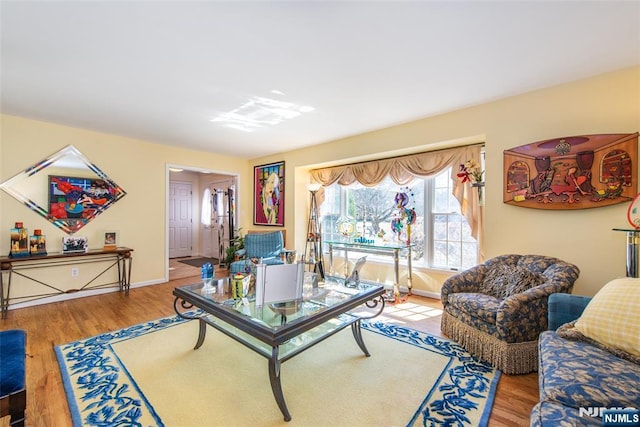 living room with baseboards and wood finished floors