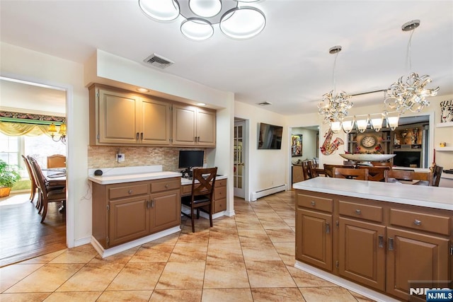 kitchen with light countertops, visible vents, and baseboard heating