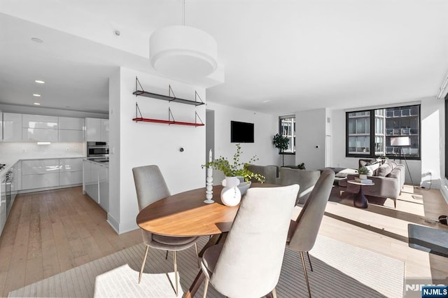 dining room featuring recessed lighting and light wood finished floors