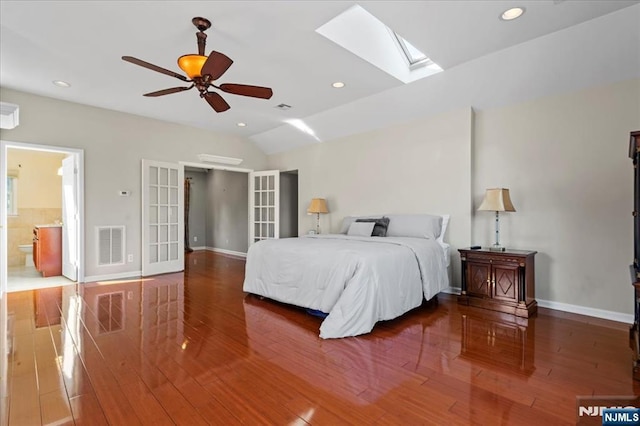 bedroom with visible vents, baseboards, lofted ceiling with skylight, recessed lighting, and wood finished floors