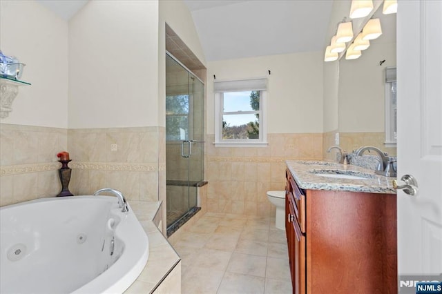 bathroom featuring a shower stall, toilet, tile patterned floors, a tub with jets, and vanity