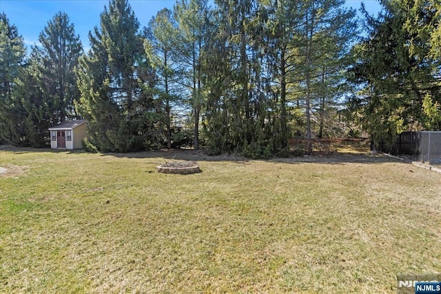 view of yard featuring an outdoor structure and fence