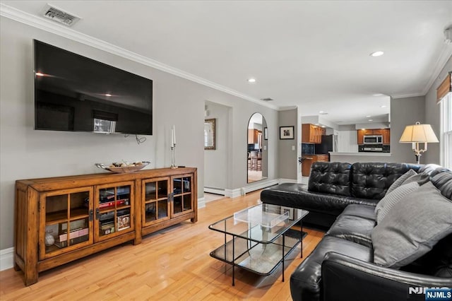 living room featuring visible vents, crown molding, recessed lighting, light wood-style floors, and arched walkways