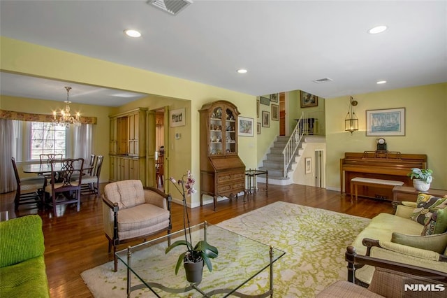 living room featuring stairs, recessed lighting, wood finished floors, and visible vents