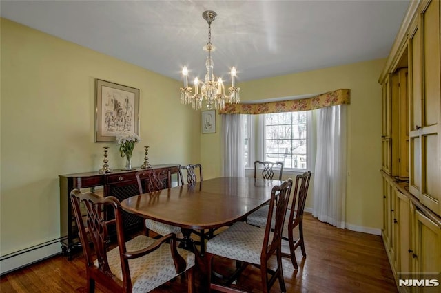 dining space featuring a chandelier, a baseboard heating unit, dark wood-type flooring, and baseboards