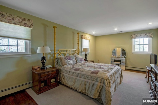 bedroom with visible vents, recessed lighting, and a baseboard heating unit