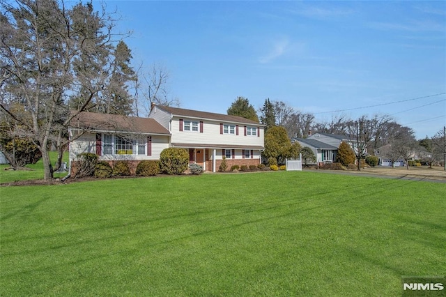 view of front of house with brick siding and a front lawn