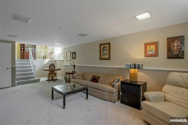 living area with visible vents, stairs, and carpet floors