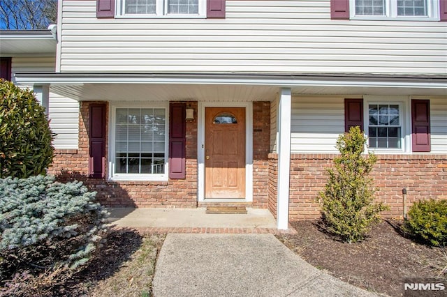 entrance to property with brick siding