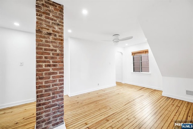 unfurnished room featuring hardwood / wood-style flooring, recessed lighting, arched walkways, baseboards, and ceiling fan