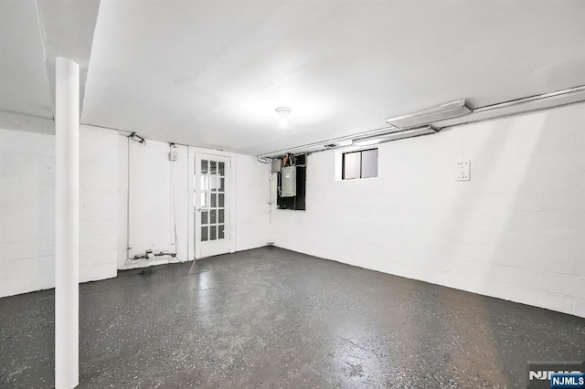 garage with electric panel and concrete block wall