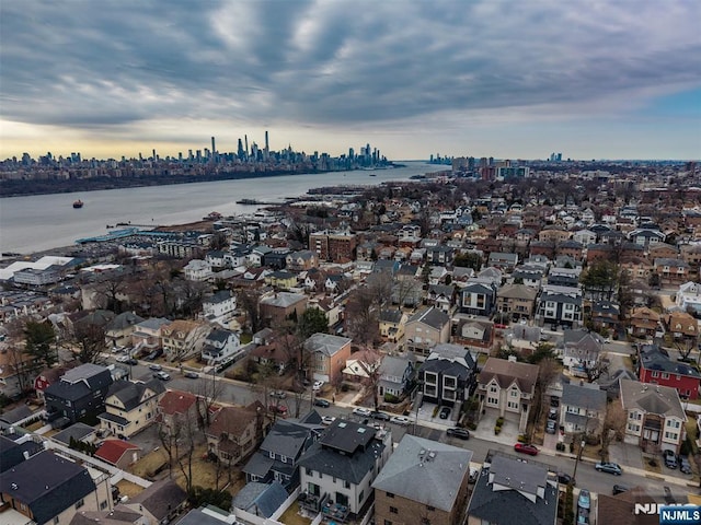 birds eye view of property with a view of city and a water view