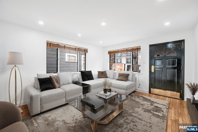 living room with recessed lighting, wood finished floors, and baseboards