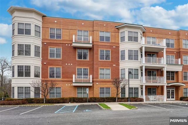 view of property featuring uncovered parking