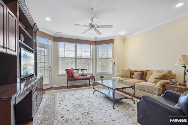 living room featuring wood finished floors, ceiling fan, and ornamental molding