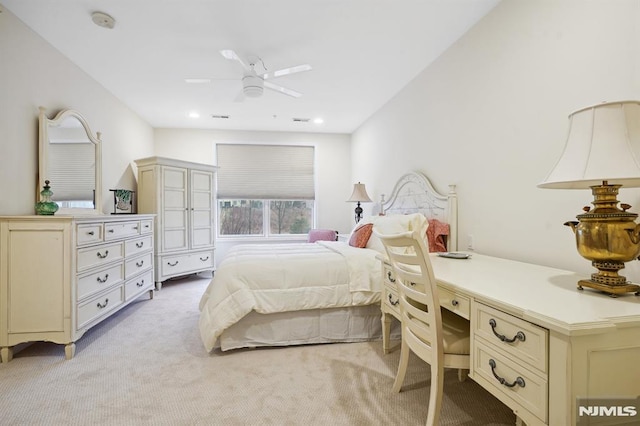 bedroom featuring light carpet and built in study area