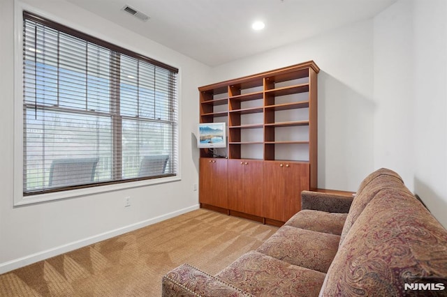 living area featuring recessed lighting, light colored carpet, visible vents, and baseboards