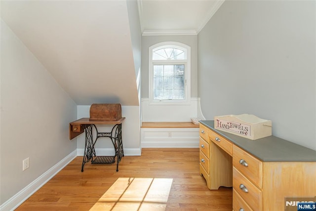 interior space with lofted ceiling, crown molding, baseboards, and light wood finished floors