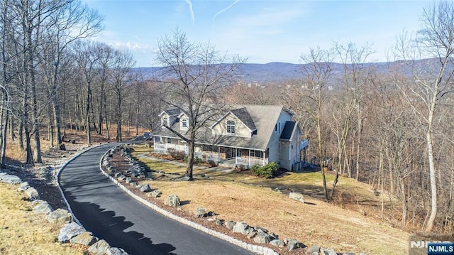 exterior space with a mountain view and a view of trees