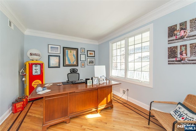 home office with visible vents, light wood-style flooring, baseboards, and ornamental molding