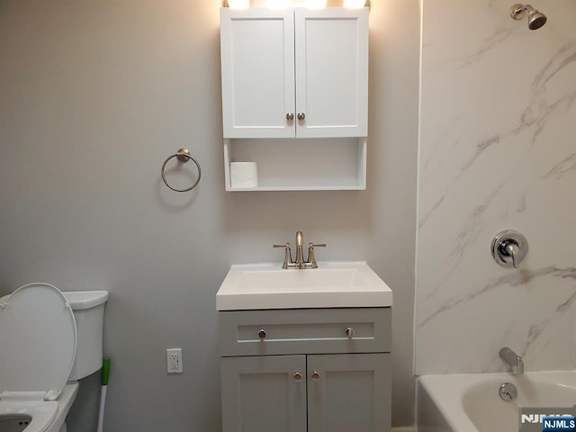 full bathroom with bathing tub / shower combination, toilet, and vanity