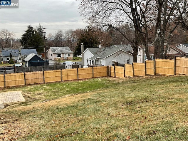 view of yard featuring a residential view and fence