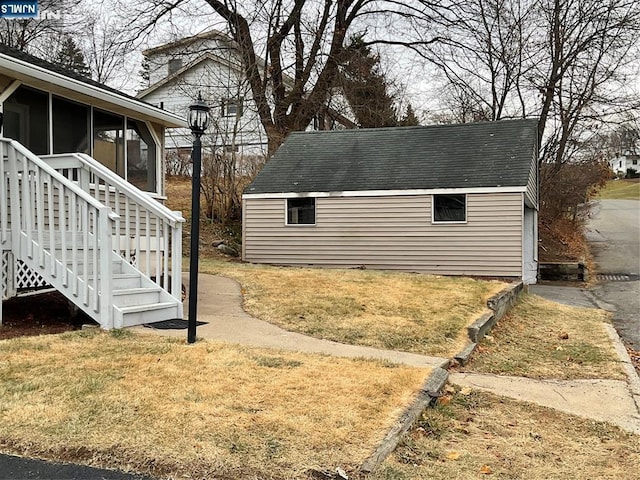 view of yard featuring stairway, an outdoor structure, and a sunroom