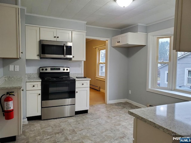 kitchen featuring light stone counters, a baseboard radiator, ornamental molding, appliances with stainless steel finishes, and white cabinetry