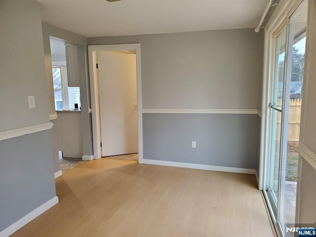 empty room with wood finished floors and baseboards