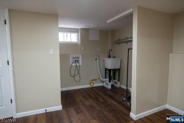 laundry area featuring laundry area, hookup for a washing machine, baseboards, and wood finished floors