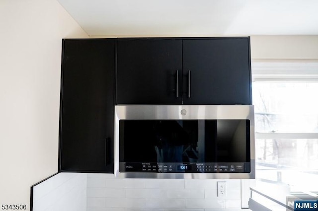 details with stainless steel microwave and dark cabinets