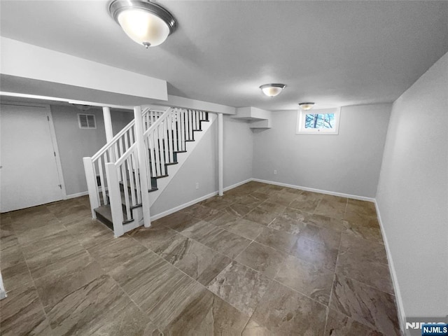 basement with stairs, baseboards, and visible vents