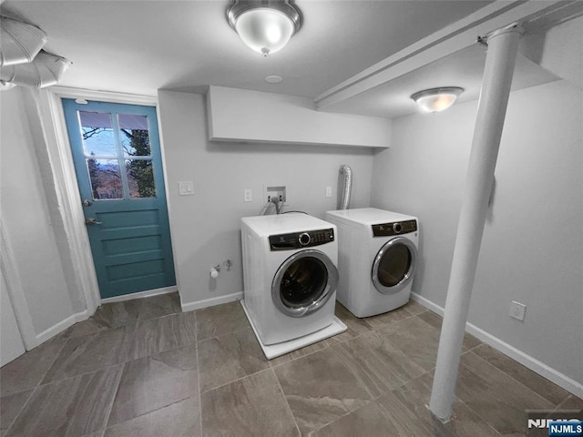 laundry room with laundry area, baseboards, and separate washer and dryer