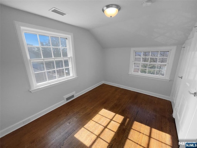 additional living space featuring visible vents, baseboards, and wood finished floors