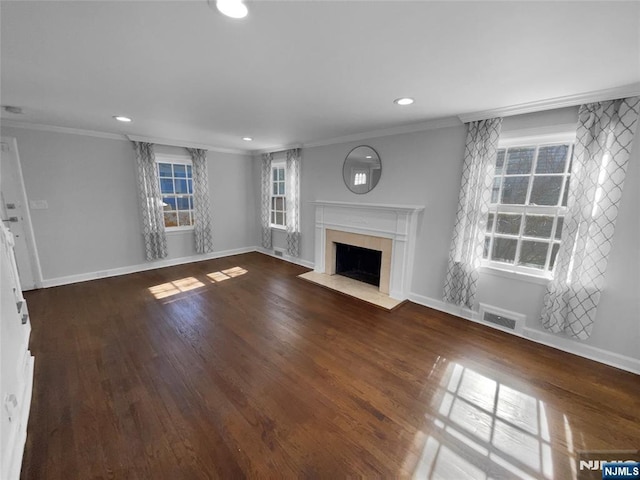 unfurnished living room with ornamental molding, wood finished floors, visible vents, and a premium fireplace